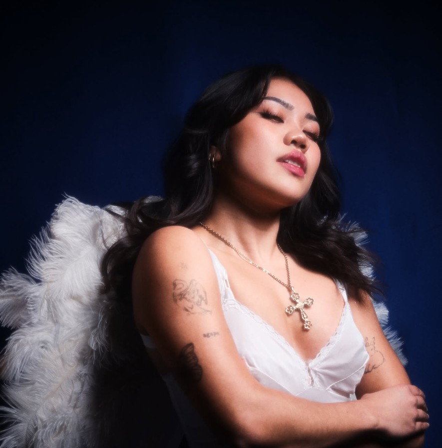 Yvette in white dress with angel wings for AGAPE: A Sinner's Thirst
