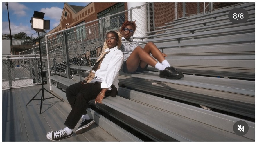 Anna and Stellae on the metal bleachers under a film light